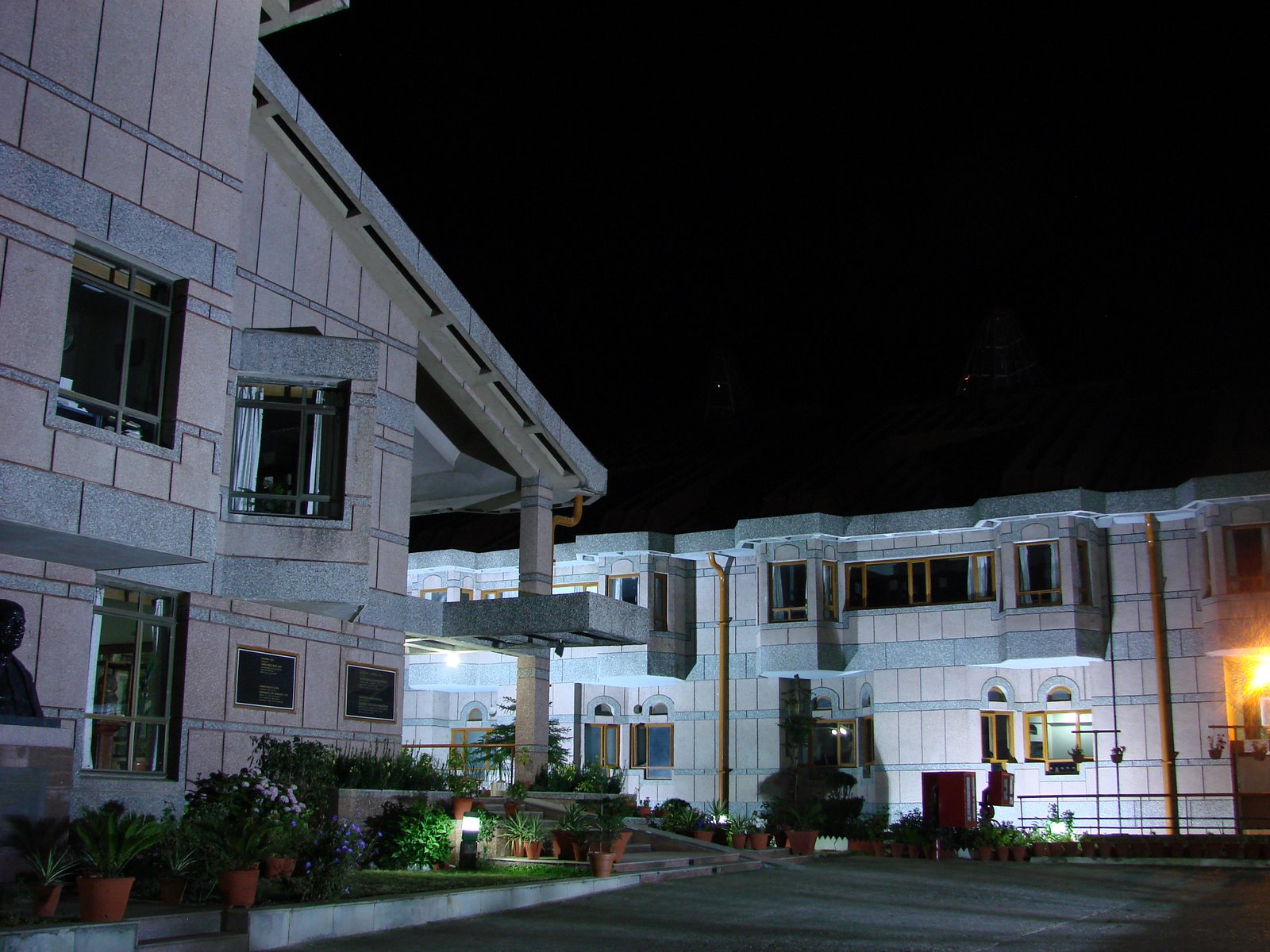 The Lal Bahadur Shastri National Academy of Administration is lit up at night, representing civil service tradition and.